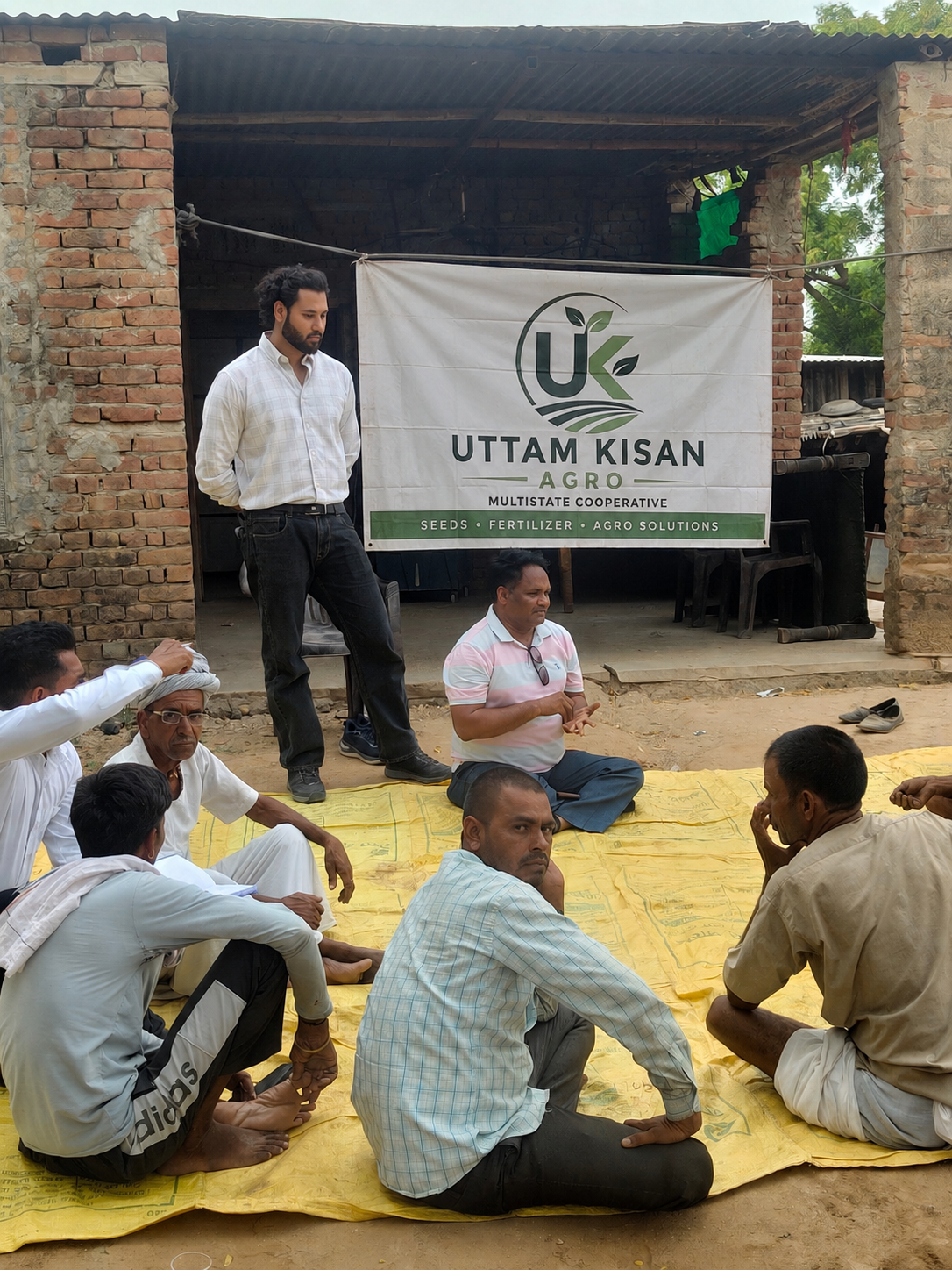 Society team holding a village meeting with farmers under the Uttam Kisan Agro banner